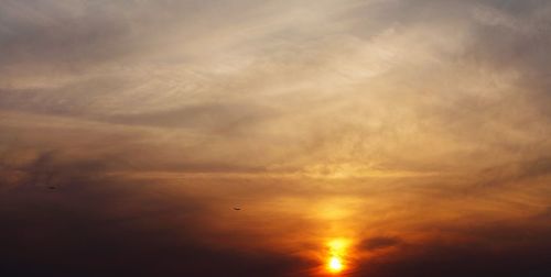 Low angle view of cloudy sky at sunset