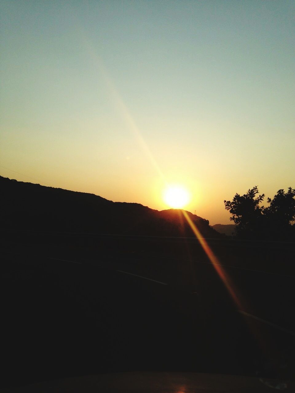 sun, sunset, sunbeam, sunlight, silhouette, lens flare, no people, road, nature, scenics, the way forward, landscape, sky, tree, beauty in nature, clear sky, outdoors, day