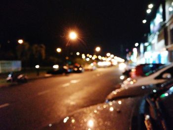 Close-up of cars on road at night