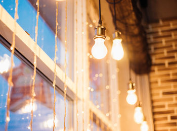 Garland and light bulbs on the window. festive atmosphere. blurred lights.interior decor.