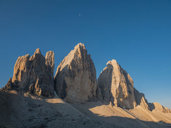 Panoramic view of rocks and mountains against clear blue sky