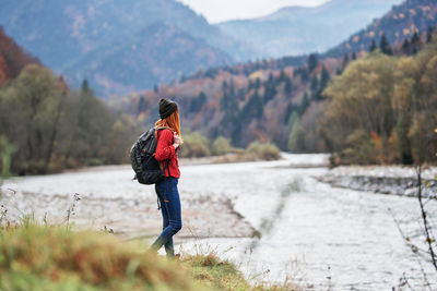 Rear view of woman standing on mountain