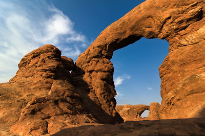 Low angle view of rock formation against sky