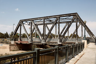 Various steel pedestrian bridges along pathway of cherry creek trail in downtown denver, colorado 