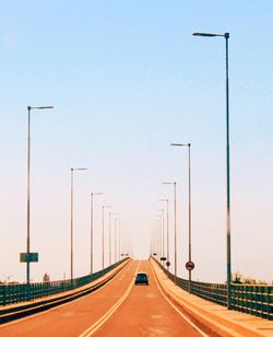 Vehicles on road against sky