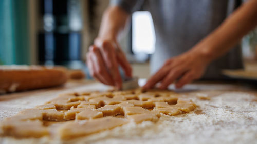 Midsection of man preparing food on table