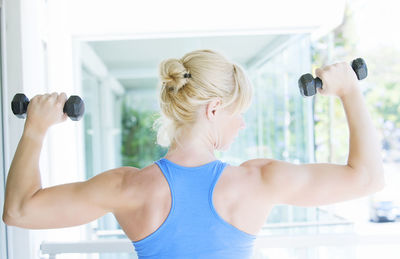 Rear view of woman exercising in gym