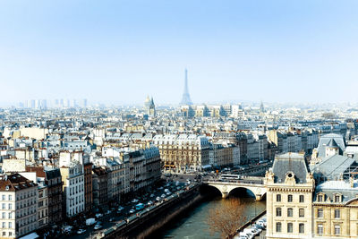 Distant view of eiffel tower against sky in city