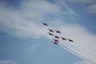 Low angle view of airshow against sky