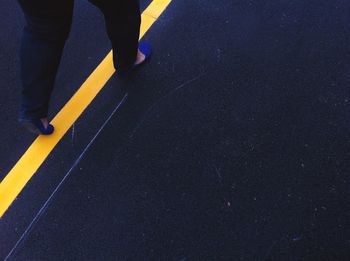 Low section of people walking on road