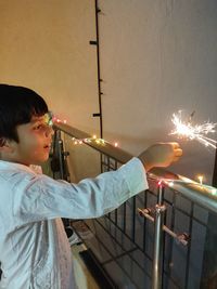Rear view of boy with arms outstretched