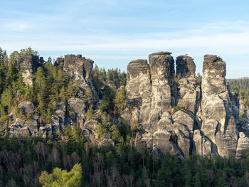 Panoramic view of rocks and trees against sky