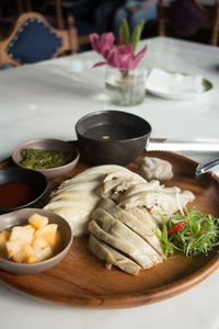 Close-up of chicken meal in plate on table