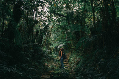 Photo of a young girl in the middle of nature looking up 