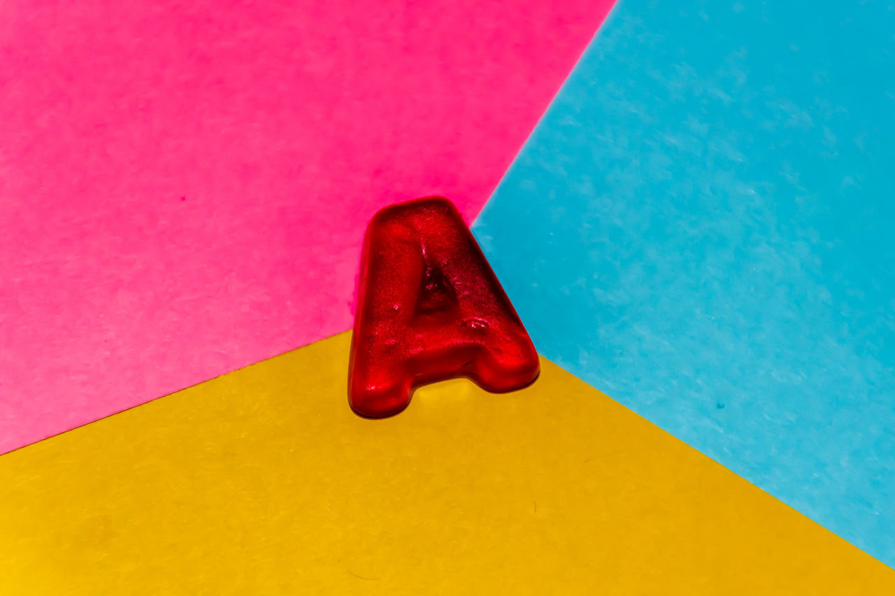 HIGH ANGLE VIEW OF MULTI COLORED PAPER ON TABLE