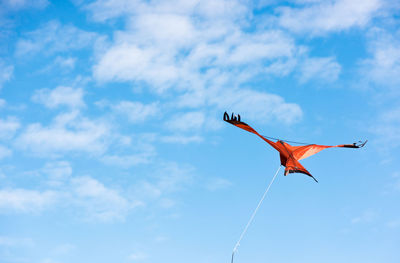 Low angle view of bird flying against sky