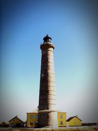 Low angle view of lighthouse against clear blue sky