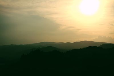 Scenic view of silhouette mountains against sky at sunset