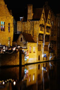 Reflection of illuminated buildings in canal at night