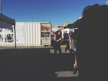 Silhouette of woman in city against clear sky