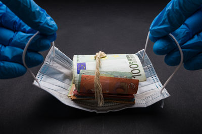 Close-up of hand holding paper