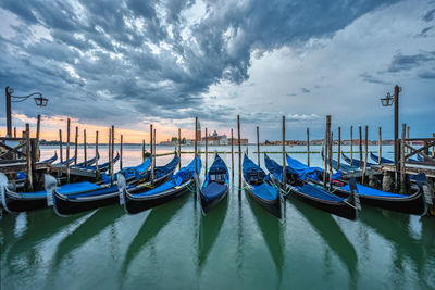 Gondolas at the st. marks square in venice, italy, before a dramatic sunrise