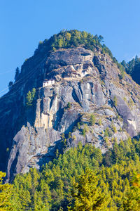 Low angle view of rocks against clear sky