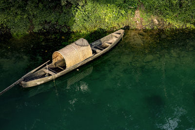 High angle view of rowboat moored in canal
