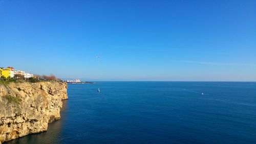Scenic view of sea against clear blue sky