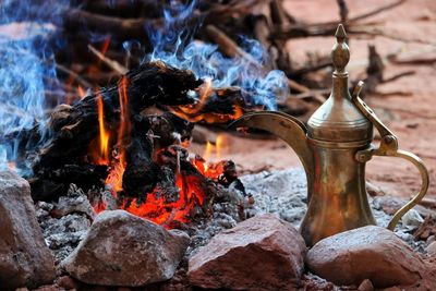 Close-up of jug by campfire