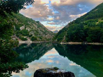 Scenic view of lake and mountains against sky