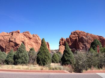 Scenic view of rocks against clear blue sky