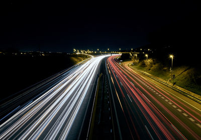 High angle view of light trails on road at night