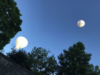 Low angle view of hot air balloon against blue sky