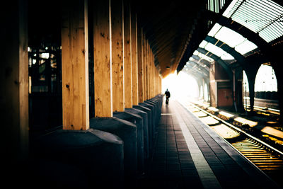 Distant view of person on railroad station platform