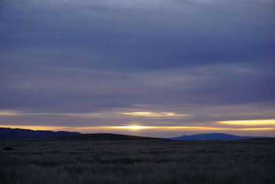 Scenic view of field against sky during sunset