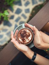 Midsection of woman holding coffee cup