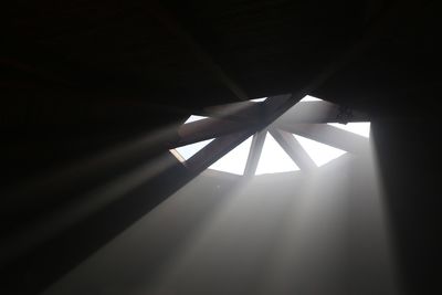 Low angle view of sunlight falling from ceiling