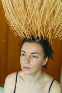 Close-up portrait of a young woman at home