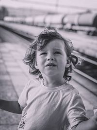 Close-up of cute boy standing at railroad station platform