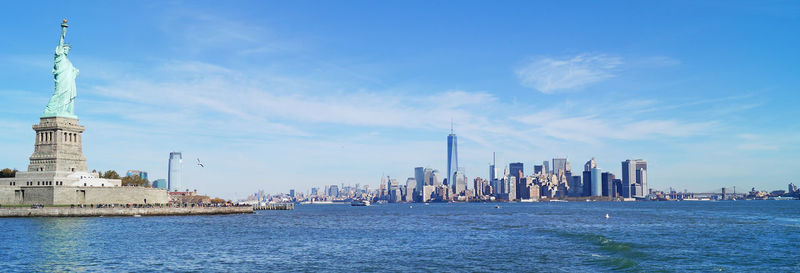 Statue of liberty with cityscape in background