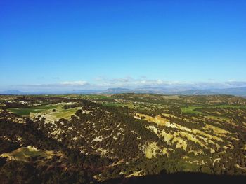 Scenic view of landscape against blue sky