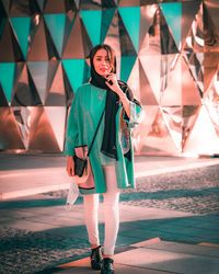 Full length of young woman walking on street