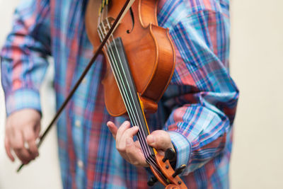 Midsection of woman playing guitar