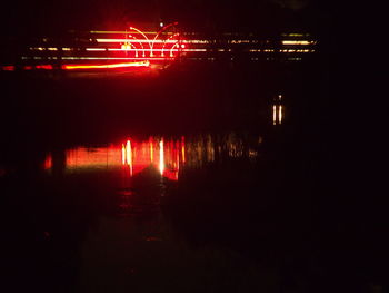 Reflection of illuminated lights in puddle