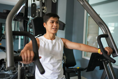 Young woman exercising in gym