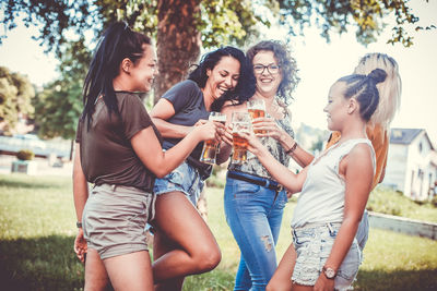 Happy young woman drinking glass with drink