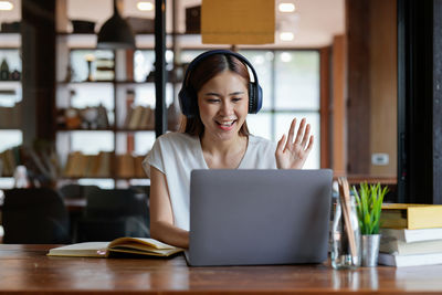 Businesswoman using laptop at table