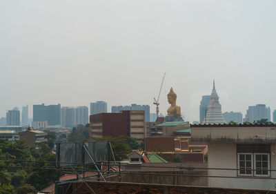 Buildings in city against clear sky