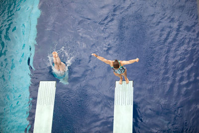 High angle view of people by swimming pool